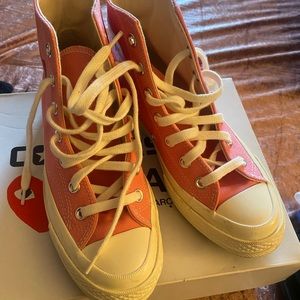 Pink and white high top converse.